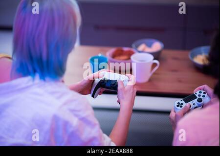 Portrait of emotional young couple playing video game at home. Stock Photo