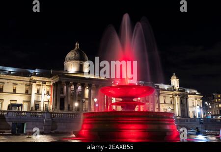 London, UK. 10th Feb, 2021. Photo taken on Feb. 10, 2021 shows the fountain illuminated in red to celebrate the forthcoming Chinese Lunar New Year, the Year of the Ox, at Trafalgar Square in London, Britain. Credit: Han Yan/Xinhua/Alamy Live News Stock Photo