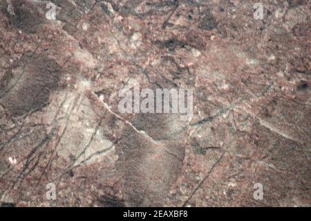 Brown onyx, a flat surface of a natural dark stone with cracks and blotches of black. Background, pattern, texture. Stock Photo