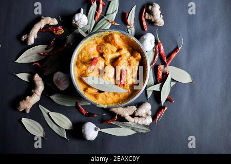 Raw marinated chicken with ginger, garlic, bay leaf, dry red chilli, curd, turmeric etc. Stock Photo