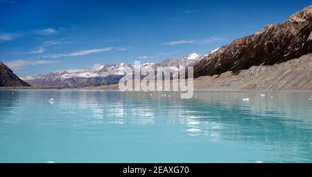 Mini icebergs on Tasman Glacier lake in Mt Cook National Park. The blue water is caused by glacial melt Stock Photo