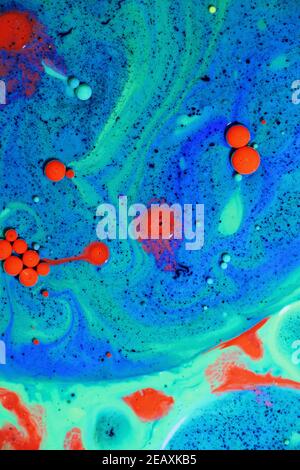 Fluent art with acrylic paint and ink in shades of red, blue, purple and green. colorful marble texture floor Stock Photo