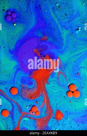 Fluent art with acrylic paint and ink in shades of red, blue, purple and green. colorful marble texture floor Stock Photo