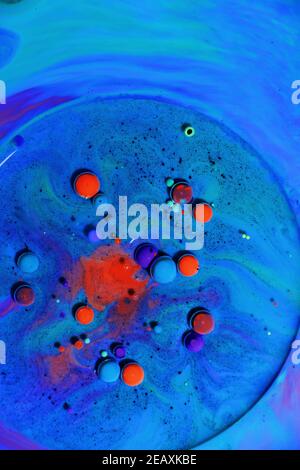 Fluent art with acrylic paint and ink in shades of red, blue, purple and green. colorful marble texture floor Stock Photo