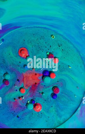 Fluent art with acrylic paint and ink in shades of red, blue, purple and green. colorful marble texture floor Stock Photo