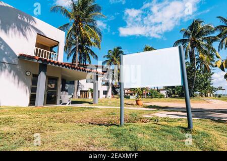 Blank Real Estate Sign in Front of Beautiful New House. space for text or advertising. mockup Stock Photo