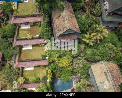 wonderful panorama of the roofs of cottages in a green oasis,the view from the top. Stock Photo