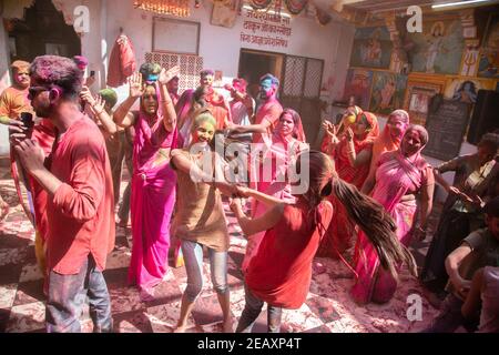 Jodhpur, rajastha, india - March 20, 2020: indian women celebrating holi festival with colored powder, dancing and enjoying. Stock Photo