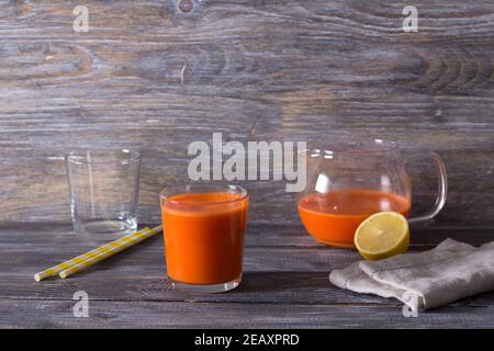 Fresh carrot juice in a glasses on a wooden background, free space Stock Photo