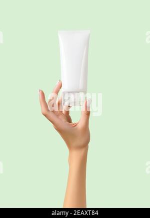 Womans hand holding white tube on pastel green background Stock Photo
