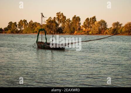 Ancient boats over 100 years old along the guadalquivir river in Seville in Andalusia Stock Photo