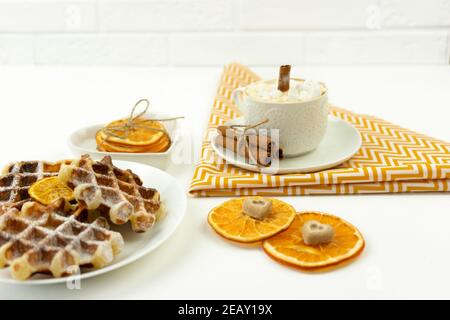 Early breakfast coffee with marshmallows and a stick of cinnamon and Belgian waffles Stock Photo