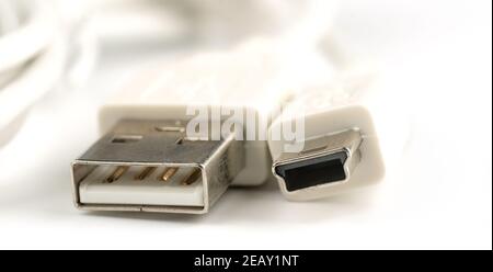 Macro shot of USB connectors on a white cable. Various types of USB connectors. Stock Photo
