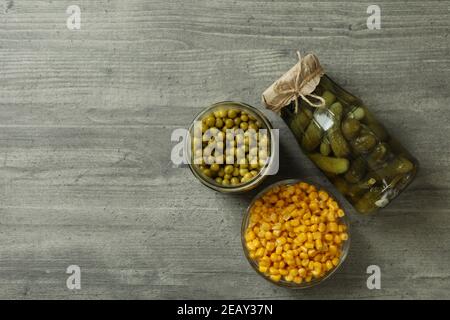 Pickled cucumbers, corn and peas on gray background Stock Photo