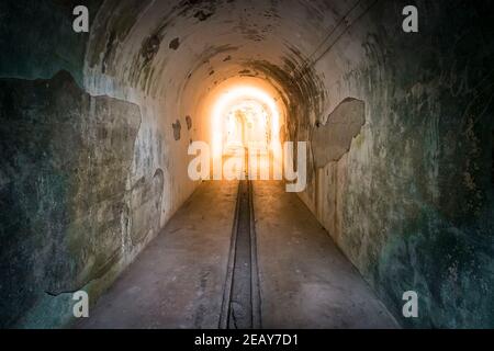 tunnel to the bomb shelter in motion. light at the end of the tunnel. Tunnel in underground protective bunker. Protection against nuclear attack. Stock Photo
