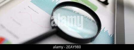 Magnifier glasses lie on table with documents in office Stock Photo