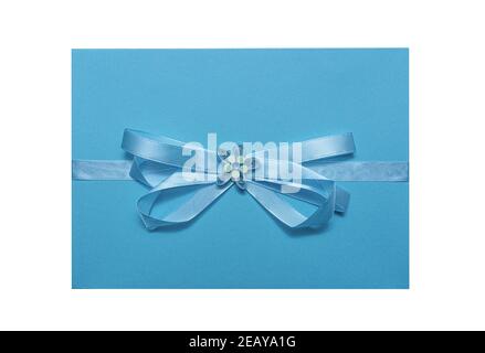 Blue envelope with ribbon and flower isolated on white. Stock Photo