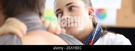 Doctor conducts auscultation of the patient's lungs Stock Photo