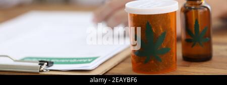 Doctor writes prescription for cannabis extract and leaves closeup Stock Photo