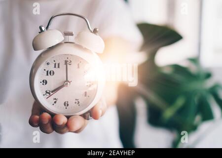Selective focus of alarm clock with nature bokeh background. lifestyle  productive life concept. Stock Photo