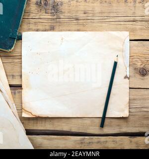 Sheets of old vintage paper on a wooden table. Copy space Stock Photo