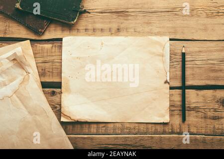 Sheets of old vintage paper on a wooden table. Copy space Stock Photo