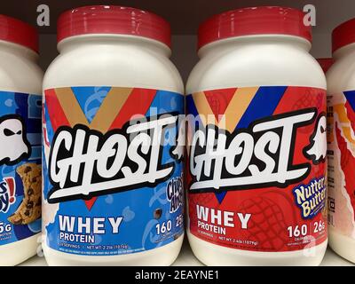 FRESNO, UNITED STATES - Feb 10, 2021: A close up photo of two New bright colorful Ghost Whey Protein Powder in plastic containers on shelf Stock Photo