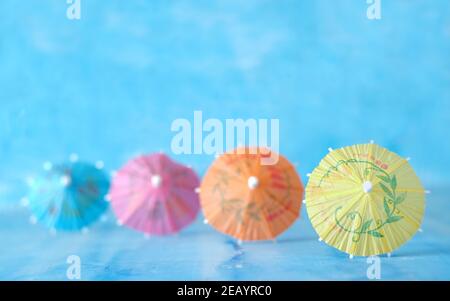 Multicolored Cocktail Umbrellas, spring and summer holidays symbol, selective focus, free copy space Stock Photo