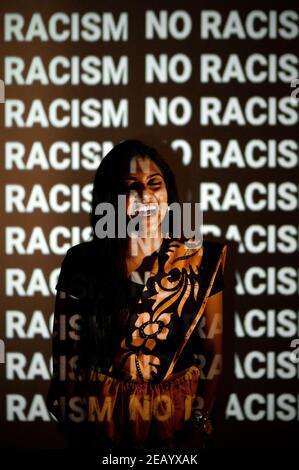 Smiling Indian Woman against a background with write no racism. Stock Photo