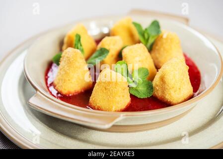 portion of fresh made fried camembert cheese served with berry jam Stock Photo