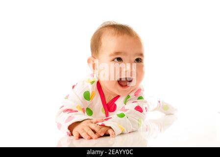 6 month old baby girl crawling on white background. Stock Photo