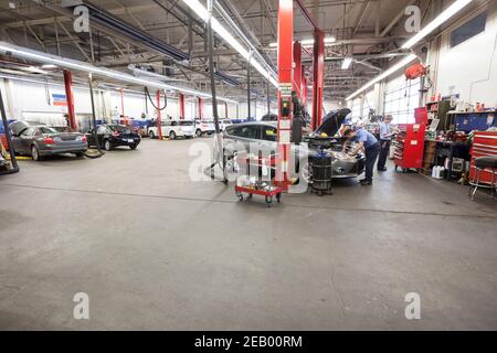 Rows of cars and trucks in auto repair shop Stock Photo