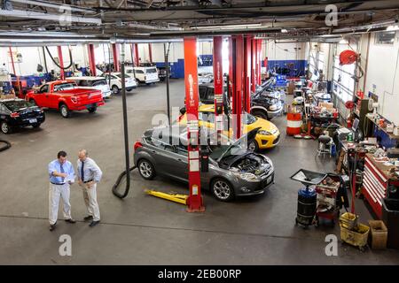 Two business men talking in auto repair shop Stock Photo