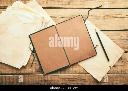 Vintage paper. Old notepad on a wooden background. Copy space Stock Photo