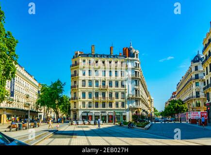 LYON, FRANCE, JULY 22, 2017: People are strolling among notable building on Place de la republique in the historical center of Lyon, France