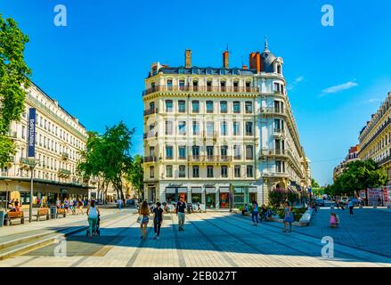LYON, FRANCE, JULY 22, 2017: People are strolling among notable building on Place de la republique in the historical center of Lyon, France