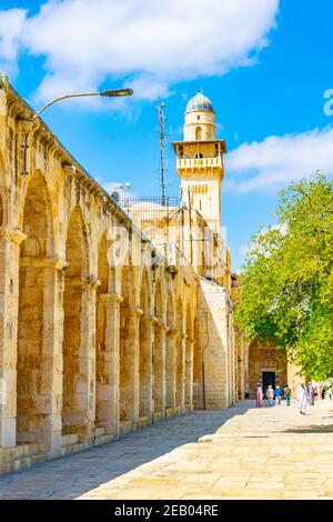 JERUSALEM, ISRAEL, SEPTEMBER 6, 2018: Tourists are passing a stone arcade on the way to the Al Aqsa mosque in Jerusalem, Israel Stock Photo