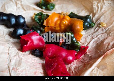 Churchkhela colorful assortment served on paper. Traditional Georgian dry sweets made of grape must juice (or other cooked fruit juice), nuts, flour. Stock Photo