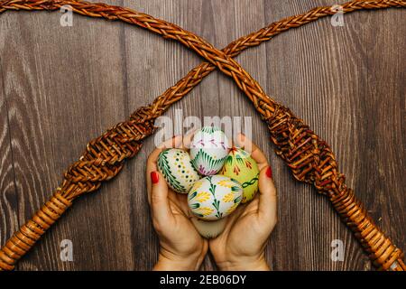 Happy Easter.Woman hands holding handmade decorated Easter eggs,DIY craft.Spring decoration background.Holiday still life photo.Home made creation. Stock Photo