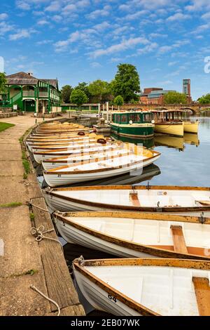 Rowing boats moored on the River Avon with the RSC Theatre in the background, Stratford Upon Avon, England Stock Photo