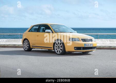 BARCELONA, SPAIN-FEBRUARY 2, 2021: 1999–2003 Audi S3  'quattro' (facelift, First generation, Typ 8L) finished in Imola Yellow next to sea. Stock Photo