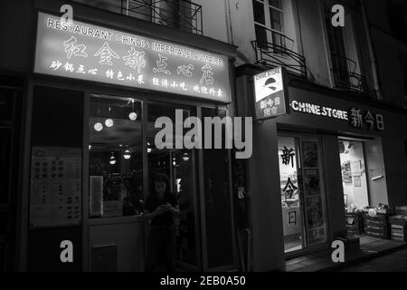 PARIS, FRANCE - OCTOBER 19, 2019:  Urban evening scene in oldest Asian quarters of Paris (3 district). People shop in local stores; eat in popular Chi Stock Photo