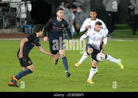 Swansea, UK. 10th Feb, 2021. Paul Arriola of Swansea city (c) in action.The Emirates FA Cup, 5th round match, Swansea city v Manchester City at the Liberty Stadium in Swansea, South Wales on Wednesday 10th February 2021. this image may only be used for Editorial purposes. Editorial use only, license required for commercial use. No use in betting, games or a single club/league/player publications. pic by Andrew Orchard/Andrew Orchard sports photography/Ģ����ý Live news Credit: Andrew Orchard sports photography/Ģ����ý Live News Stock Photo