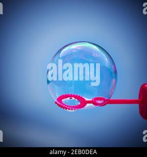 View to a soap bubble with reflections in graduated blue colors. Stock Photo
