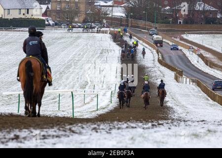 Picture dated February 9th shows jockeys and race horses out training on the all weather track in Newmarket,Suffolk,on Tuesday morning in freezing temperatures and surrounding snow.More snow and rain is forecast for the next 48 hours as Storm Darcy continues o bring bad weather to parts of the country. Stock Photo