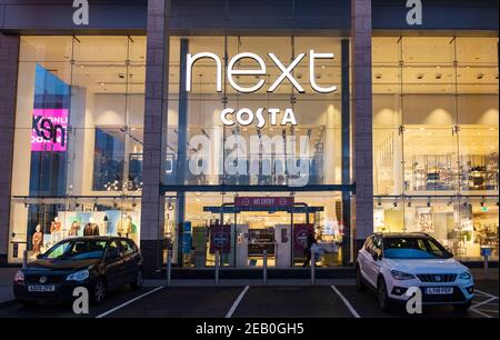 Cars parked in a quiet scene outside the NEXT plc seen in London, during the third nationwide lockdown. Next plc is a British multinational clothing, footwear and home products retailer, which has its headquarters in Enderby, England. Stock Photo