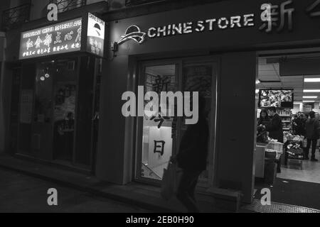 PARIS, FRANCE - OCTOBER 19, 2019:  Urban evening scene in oldest Asian quarters of Paris (3 district). People shop in local stores; eat in popular Chi Stock Photo