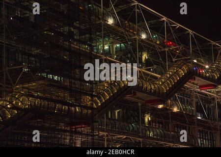 PARIS, FRANCE - OCTOBER 19, 2019: Night view of Pompidou Centre under renovation. Caterpillar escalator and the sloping stone square in front of the m Stock Photo