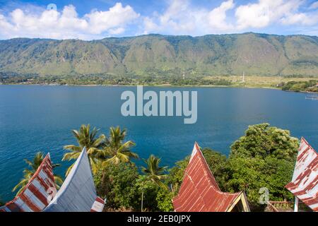 Indonesia, Sumatra, Samosir Island, Tuk Tuk, Traditional Batak houses overlooking Lake Toba Stock Photo