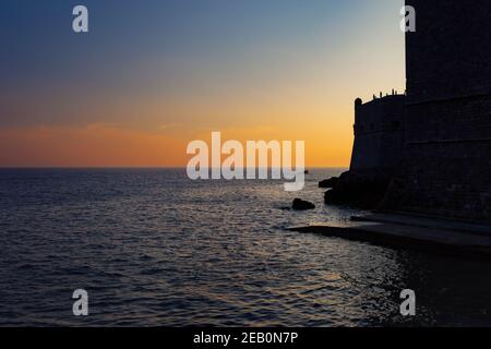 Sunset at the Adriatic Sea with Dubrovnik old city silhouette in Croatia. Stock Photo